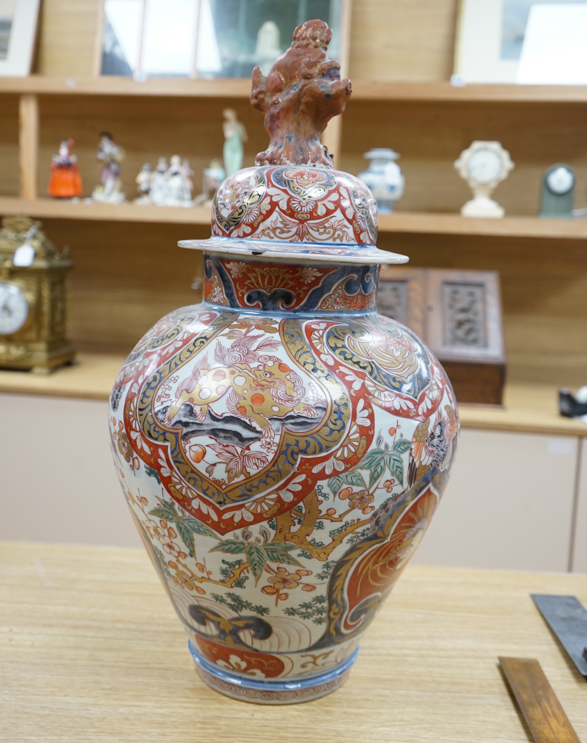 A large 19th century Imari vase with dragon finial to cover, 61cm high. Condition - badly cracked and restored